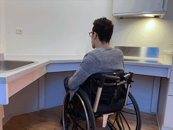 `Alexander using accessible corner kitchen worktop from wheelchair`