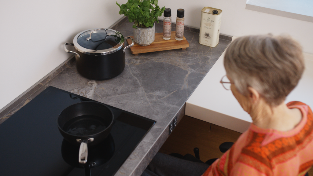 Wheelchair user in a hieght adjustable kitchen